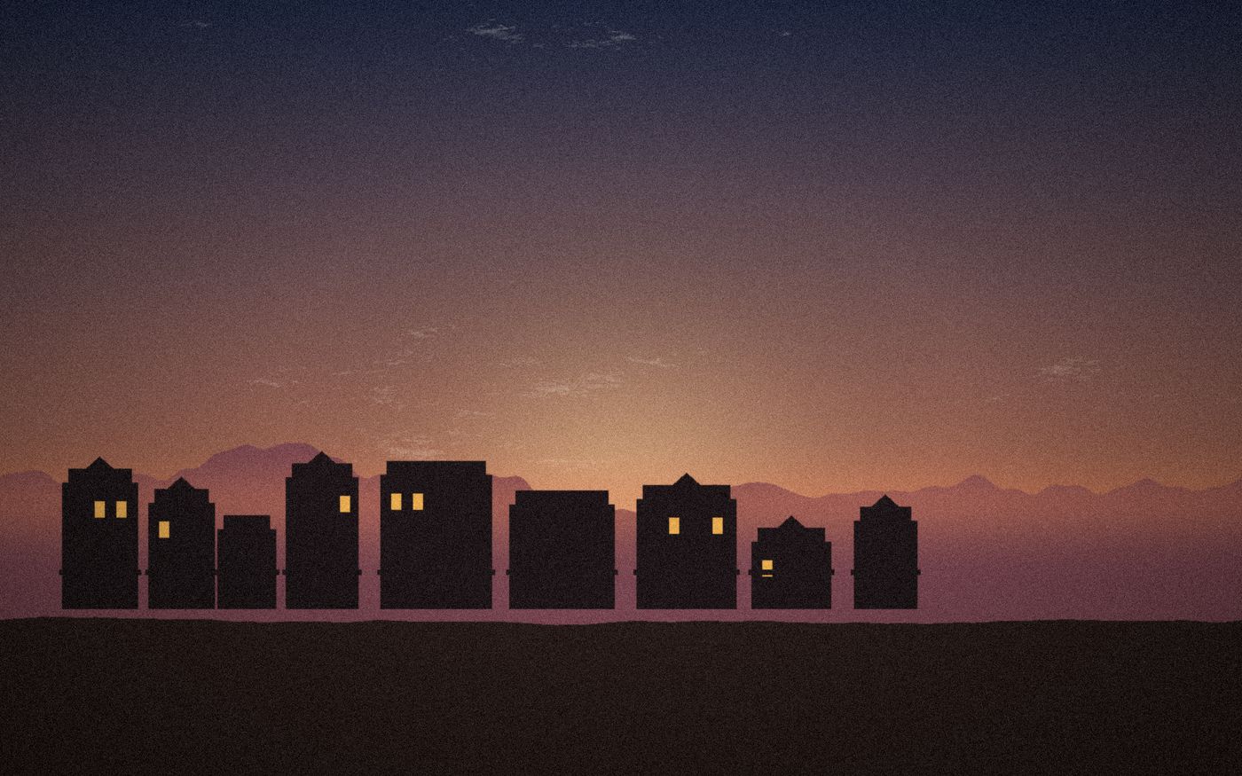 Siluetas de casas de un pueblo al atardecer